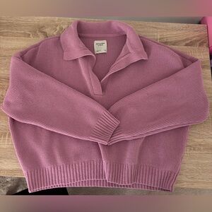 Abercrombie and Fitch notch-neck polo sweater in pink.